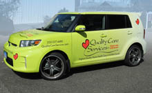 Quality care service logo printed on a car